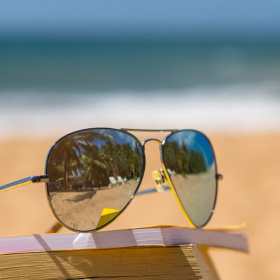 Books and sunglasses on a beach